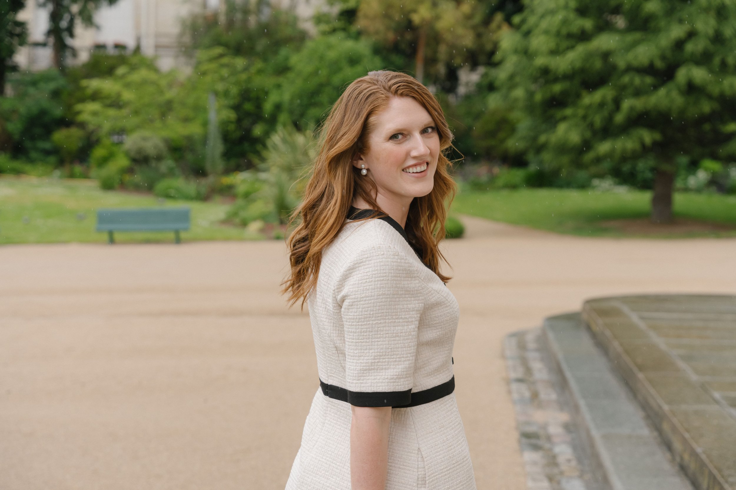 Paige brunton smiling for camera in a parisian park .jpg