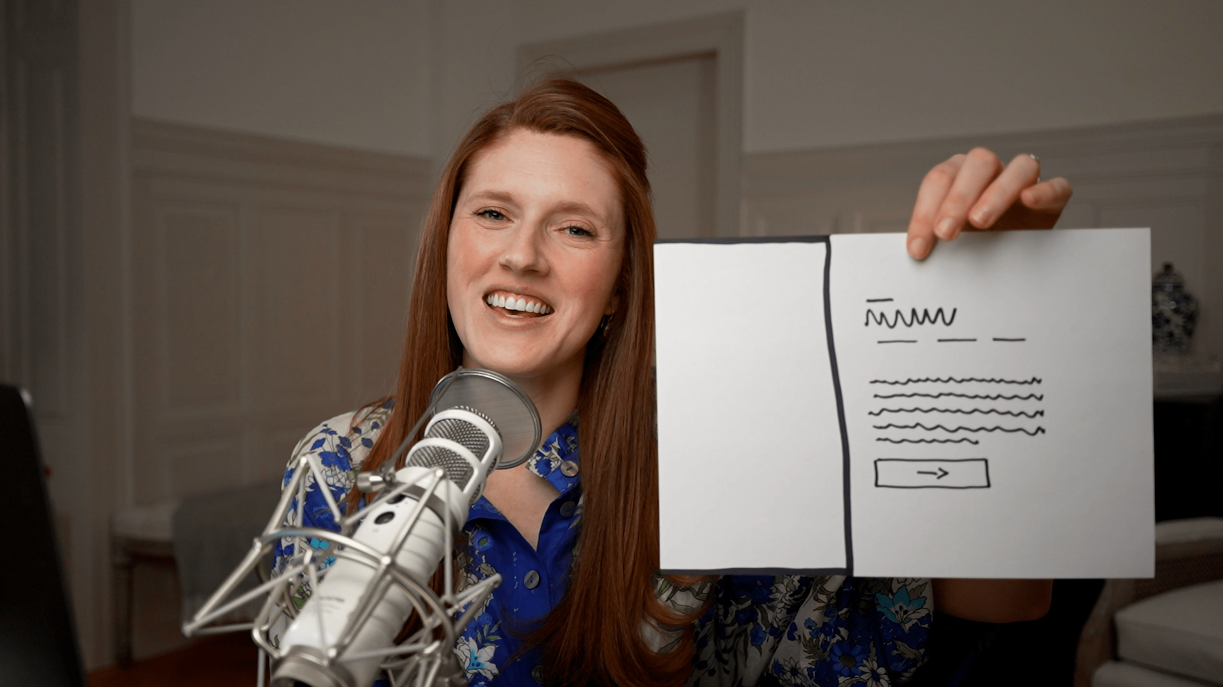 Paige holding up a website layout option featuring text adn space for an image-min.png