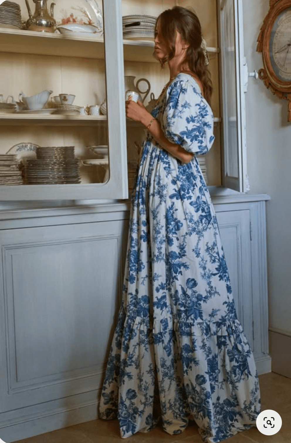 Woman wearing a blue Table Cloth patterned dress.png